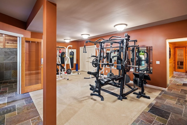 workout room with dark colored carpet