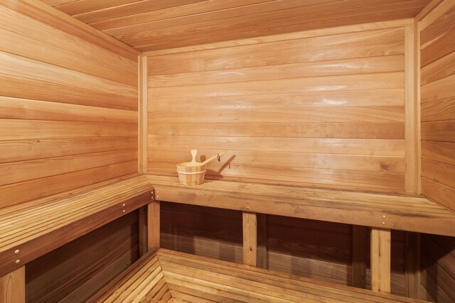 view of sauna featuring wood walls and wood ceiling