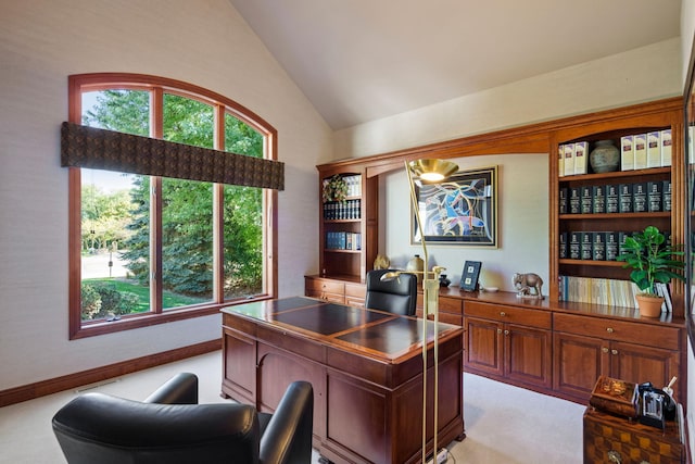 carpeted home office with high vaulted ceiling