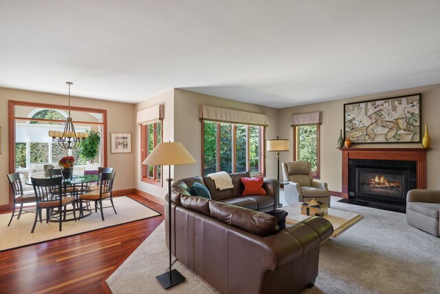 living room featuring wood-type flooring and a chandelier