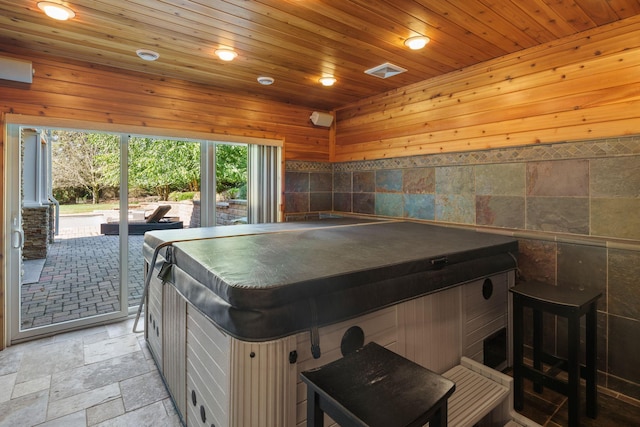 playroom featuring wood walls, wooden ceiling, and a hot tub