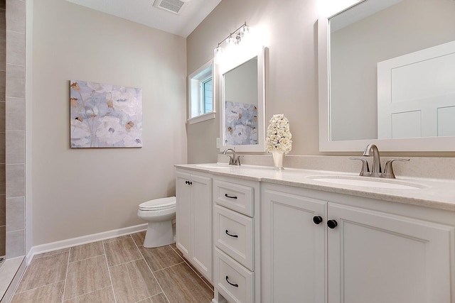 bathroom with wood-type flooring, vanity, and toilet