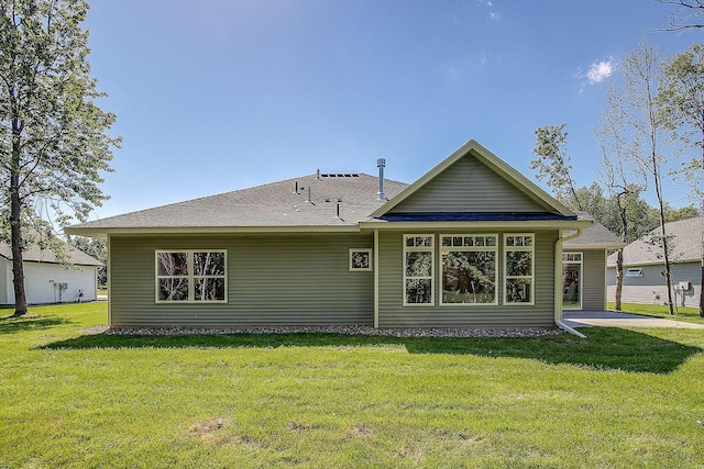 rear view of house with a yard