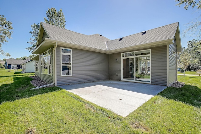 back of house featuring a patio and a yard