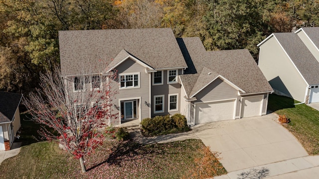 view of front of house featuring a garage and a front lawn