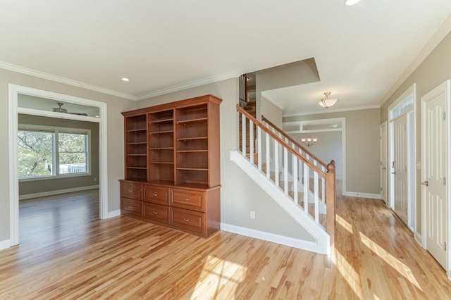 interior space featuring crown molding, a chandelier, and light wood-type flooring