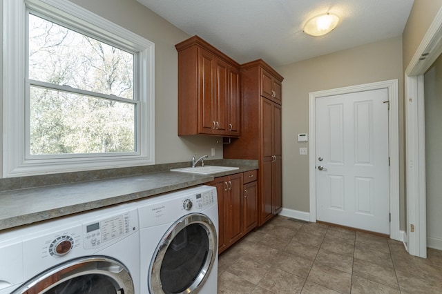 laundry room featuring cabinets, independent washer and dryer, sink, and light tile patterned flooring