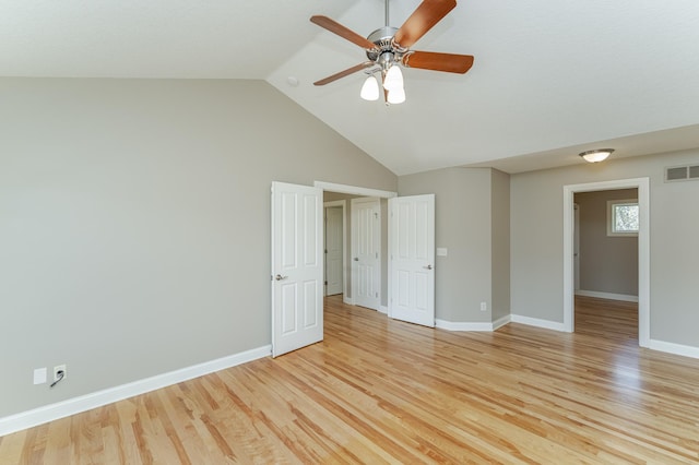 spare room with vaulted ceiling, light hardwood / wood-style flooring, and ceiling fan