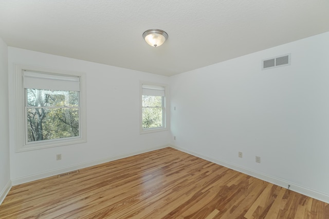 spare room with light hardwood / wood-style flooring