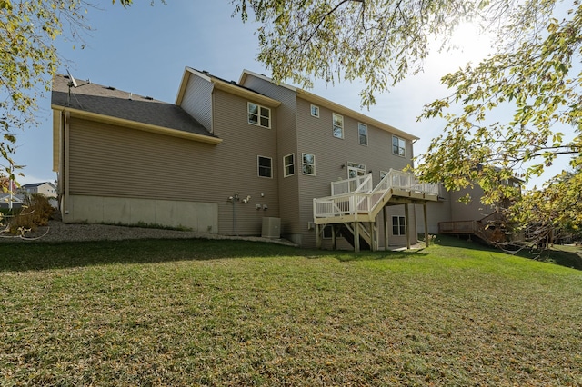 rear view of house with central air condition unit, a lawn, and a wooden deck