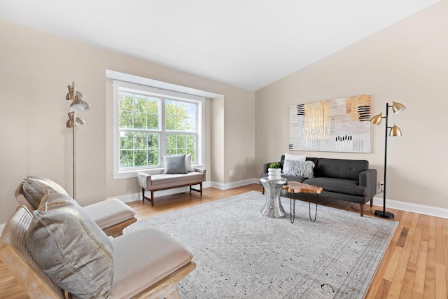 living room with light hardwood / wood-style flooring and lofted ceiling