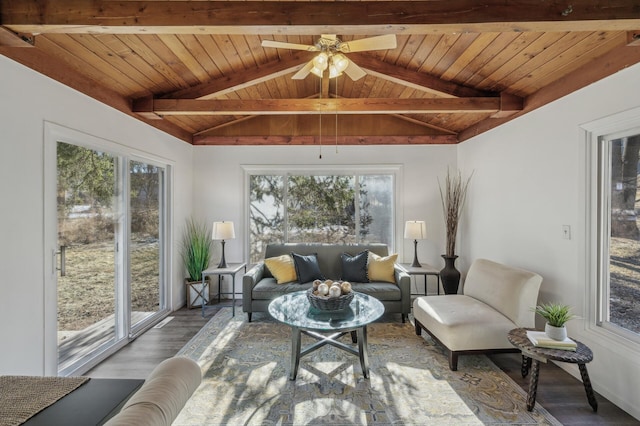 sunroom with ceiling fan, lofted ceiling with beams, and wooden ceiling