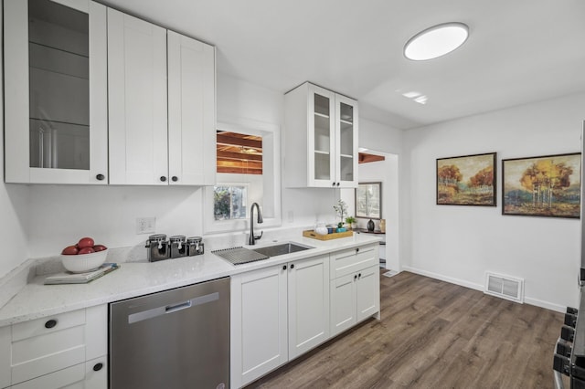 kitchen featuring sink, stainless steel dishwasher, white cabinets, and light stone countertops