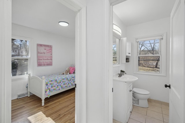 bathroom featuring vanity, hardwood / wood-style floors, and toilet