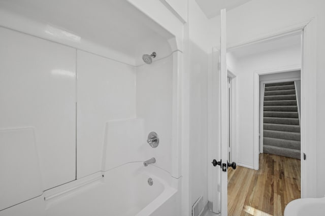 bathroom with wood-type flooring and shower / bath combination