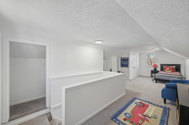 interior space with light carpet, lofted ceiling, and a textured ceiling