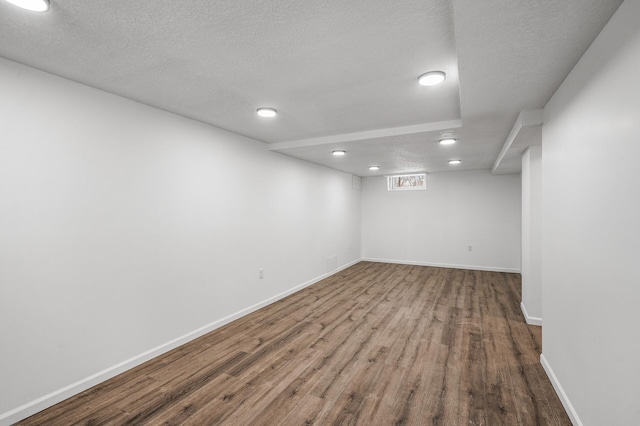 empty room featuring hardwood / wood-style floors and a textured ceiling