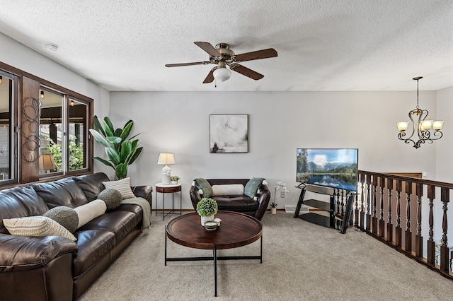 living room with light colored carpet, a textured ceiling, and ceiling fan with notable chandelier