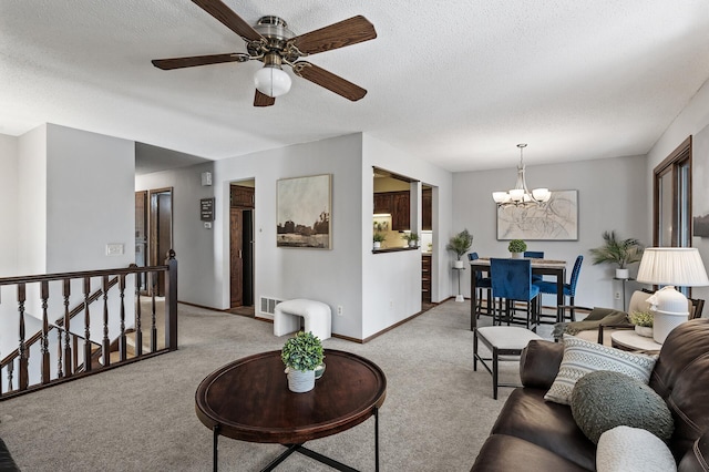 living area featuring carpet, visible vents, a textured ceiling, and baseboards