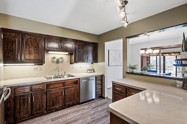 kitchen with dishwasher, light countertops, a sink, and dark brown cabinetry