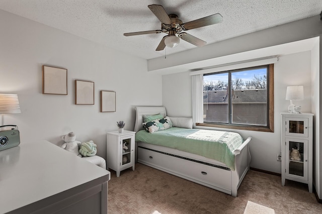 bedroom with light carpet, ceiling fan, and a textured ceiling