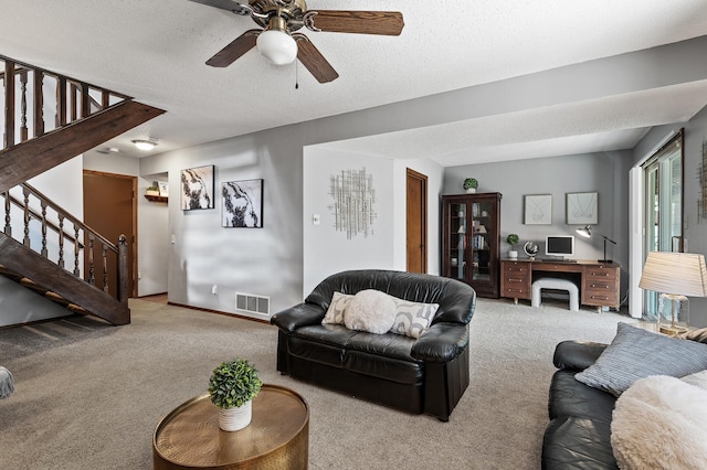 living area with baseboards, visible vents, carpet, stairs, and a textured ceiling