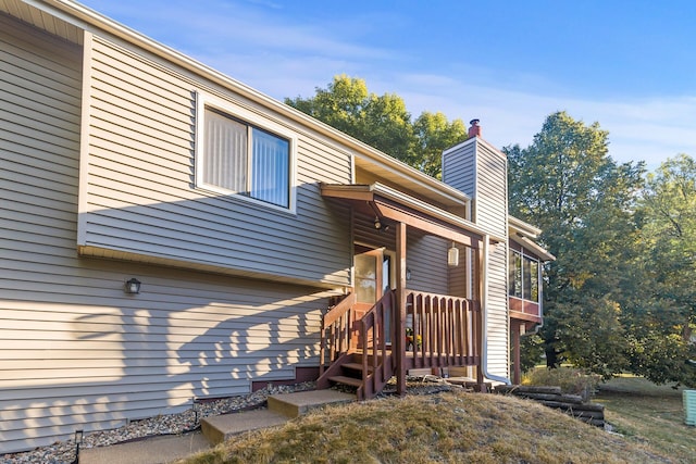 view of property exterior featuring a chimney