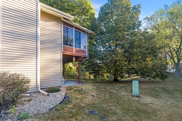 view of yard featuring a sunroom and a patio