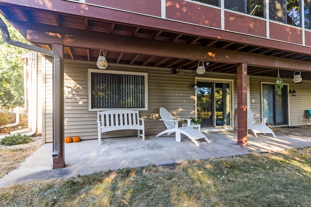 view of exterior entry with a patio area