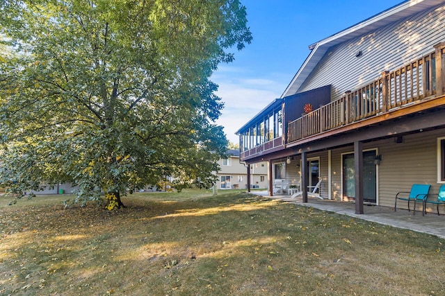 view of yard featuring a patio area and a wooden deck