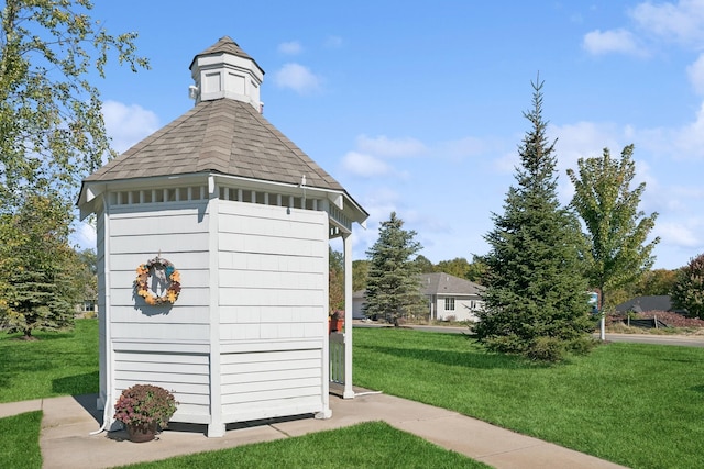 view of outbuilding with a lawn