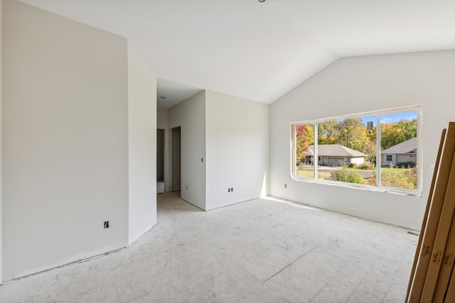 spare room featuring vaulted ceiling