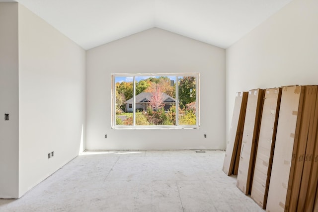 spare room featuring lofted ceiling