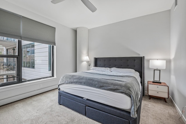 bedroom with a baseboard radiator, ceiling fan, and carpet floors