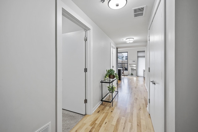 hallway with light hardwood / wood-style flooring