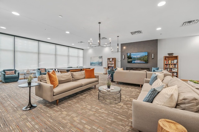 carpeted living room with an inviting chandelier