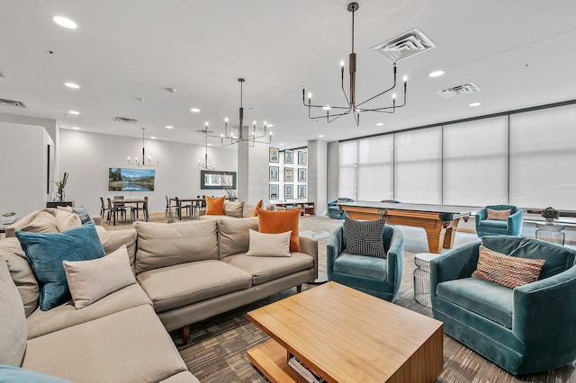 living room featuring a notable chandelier and billiards