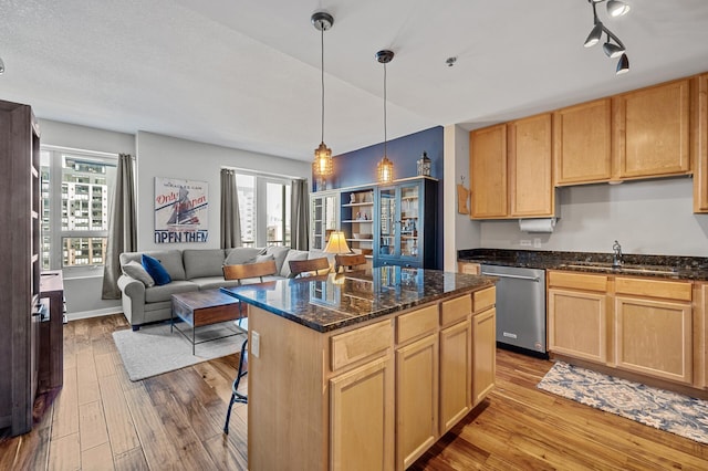 kitchen featuring light wood-type flooring, dishwasher, a healthy amount of sunlight, and sink