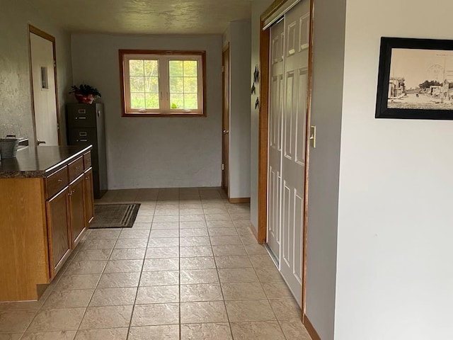 hall featuring light tile patterned floors