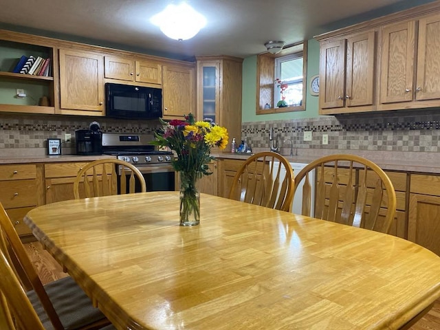 kitchen with tasteful backsplash and stainless steel range