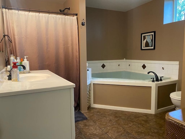 bathroom featuring tile patterned floors, a bath, vanity, and toilet