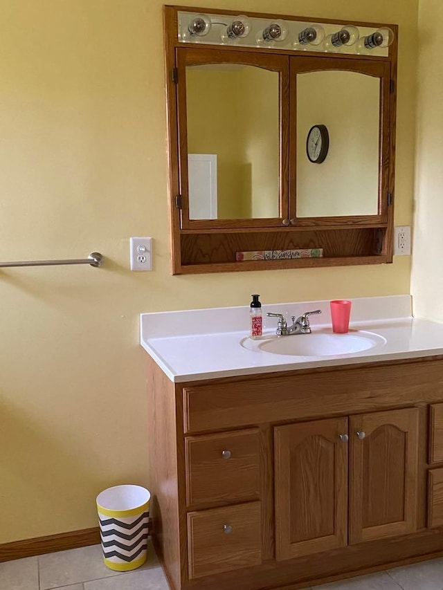 bathroom featuring tile patterned flooring and vanity