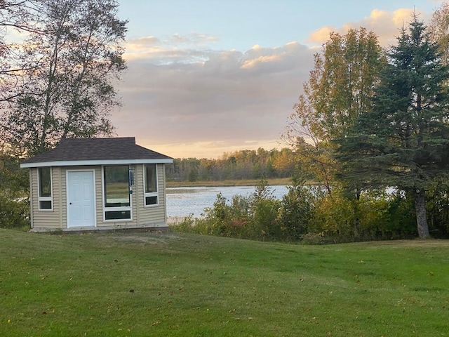 exterior space featuring a yard and a water view