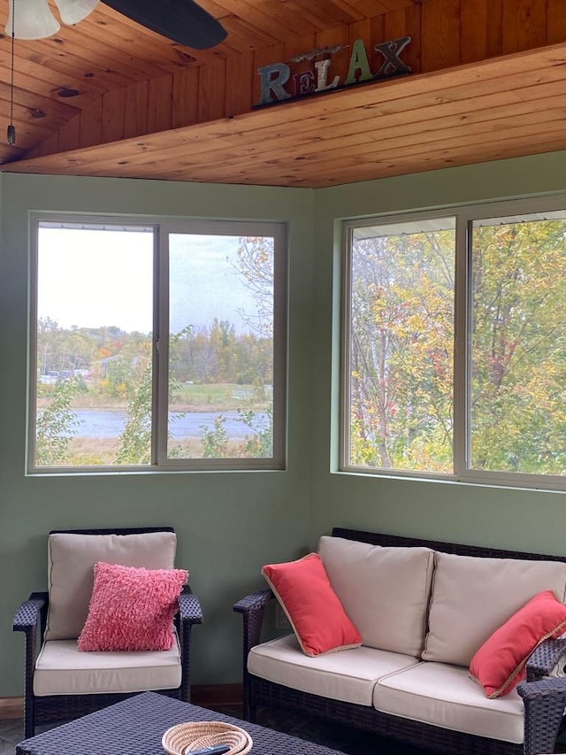 interior space featuring wood ceiling, a water view, vaulted ceiling, and a healthy amount of sunlight