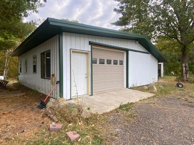 garage featuring wooden walls