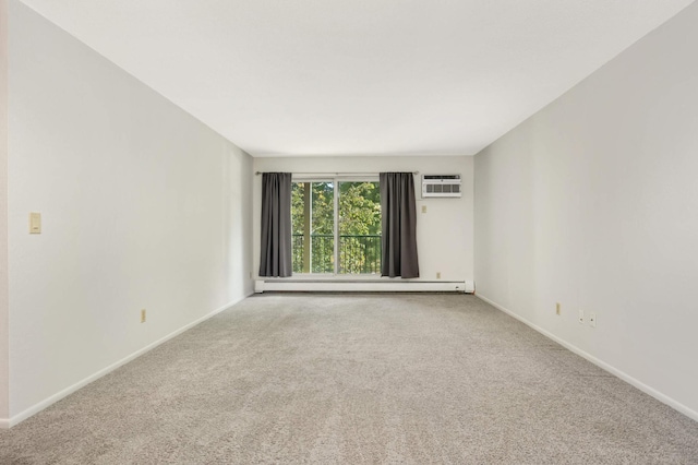 spare room with a baseboard heating unit and carpet