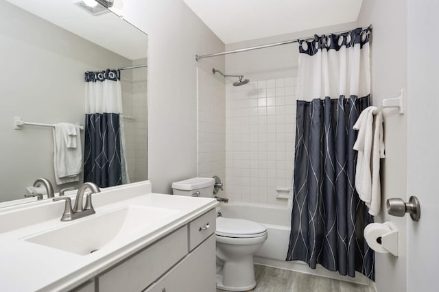 full bathroom with vanity, hardwood / wood-style floors, shower / bath combination with curtain, and toilet