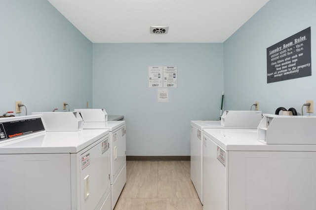 clothes washing area featuring washing machine and clothes dryer