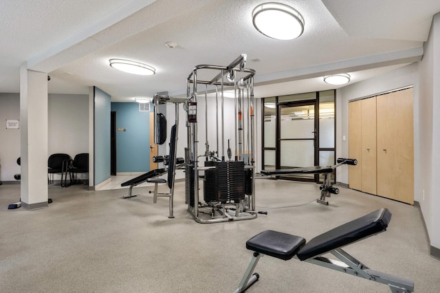 exercise room with a textured ceiling