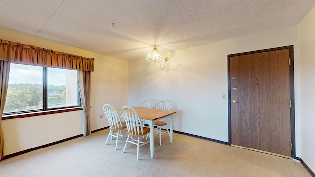 dining space featuring light carpet, a textured ceiling, and a notable chandelier